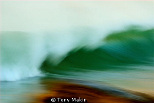Breaking wave. Taken by panning with a slow shutter speed... by Tony Makin 